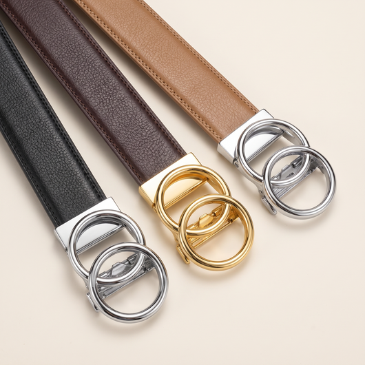 Three Crest no-hole belts fanned out with mixed gold and silver buckles