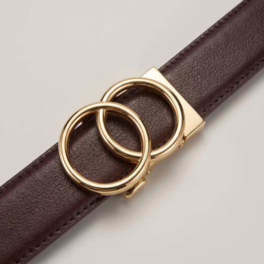 Close-up of the gold Halo buckle on a mahogany pebble-grain strap